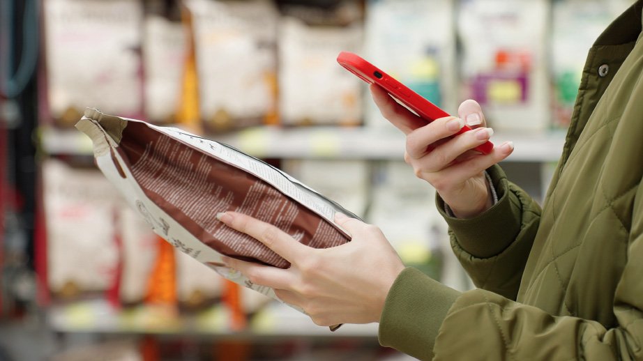 Women on her phone holding cat food